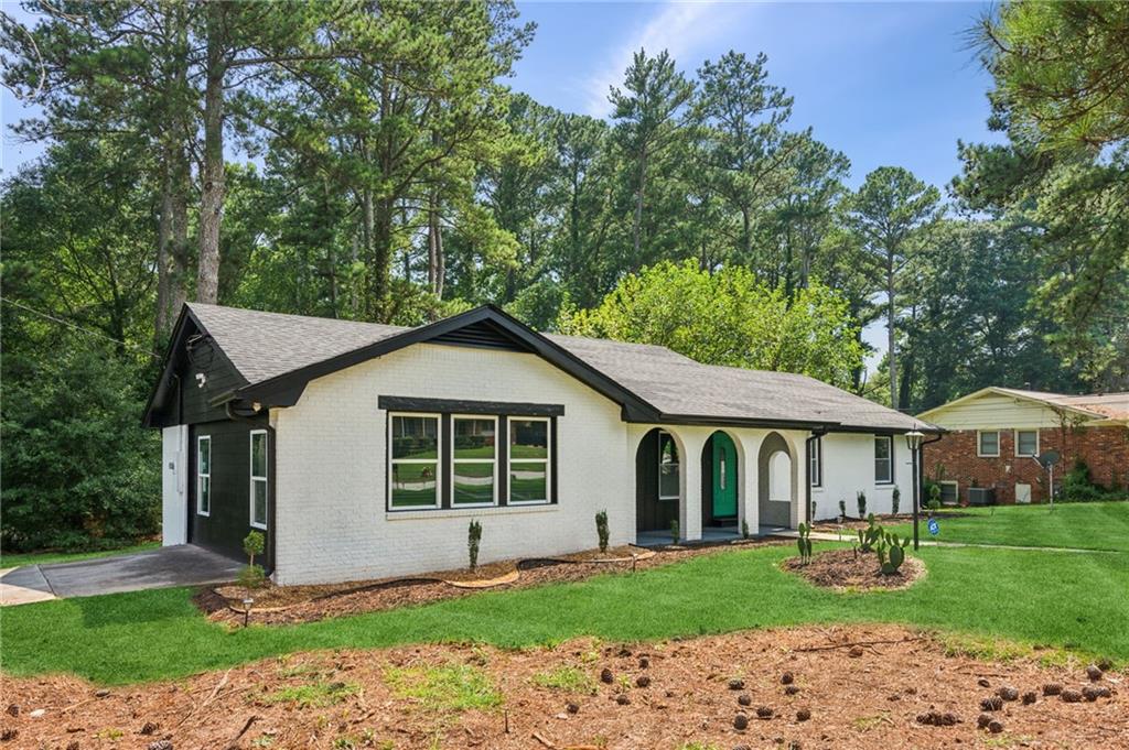 4379 John Wesley Drive Decatur, GA 30035 - Photo 1 of 1 a front view of a house with a garden and yard