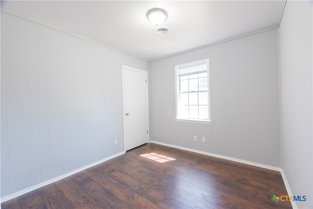 1201 Ridgemont Drive Killeen, TX 76549 - Photo 11 of 21 an empty room with wooden floor and windows