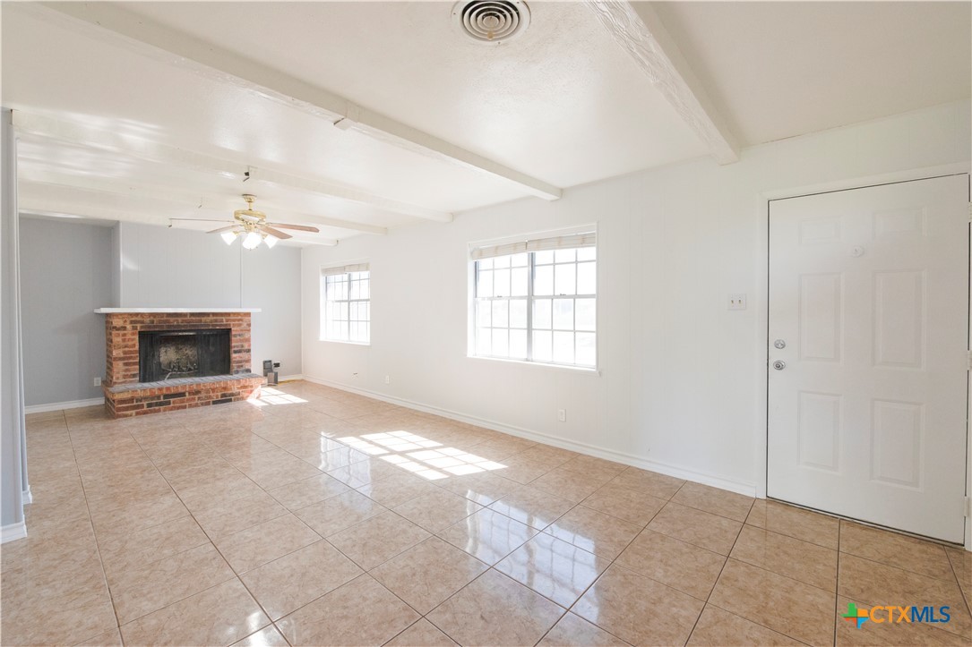 1201 Ridgemont Drive Killeen, TX 76549 - Photo 5 of 21 a view of an empty room with a fireplace and a window