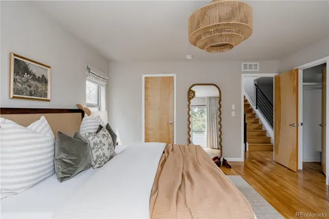 a bedroom with bed and a chandelier
