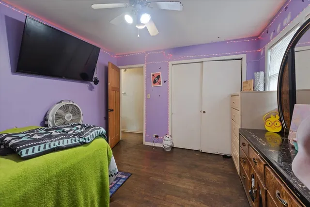 a bedroom with furniture and a flat screen tv