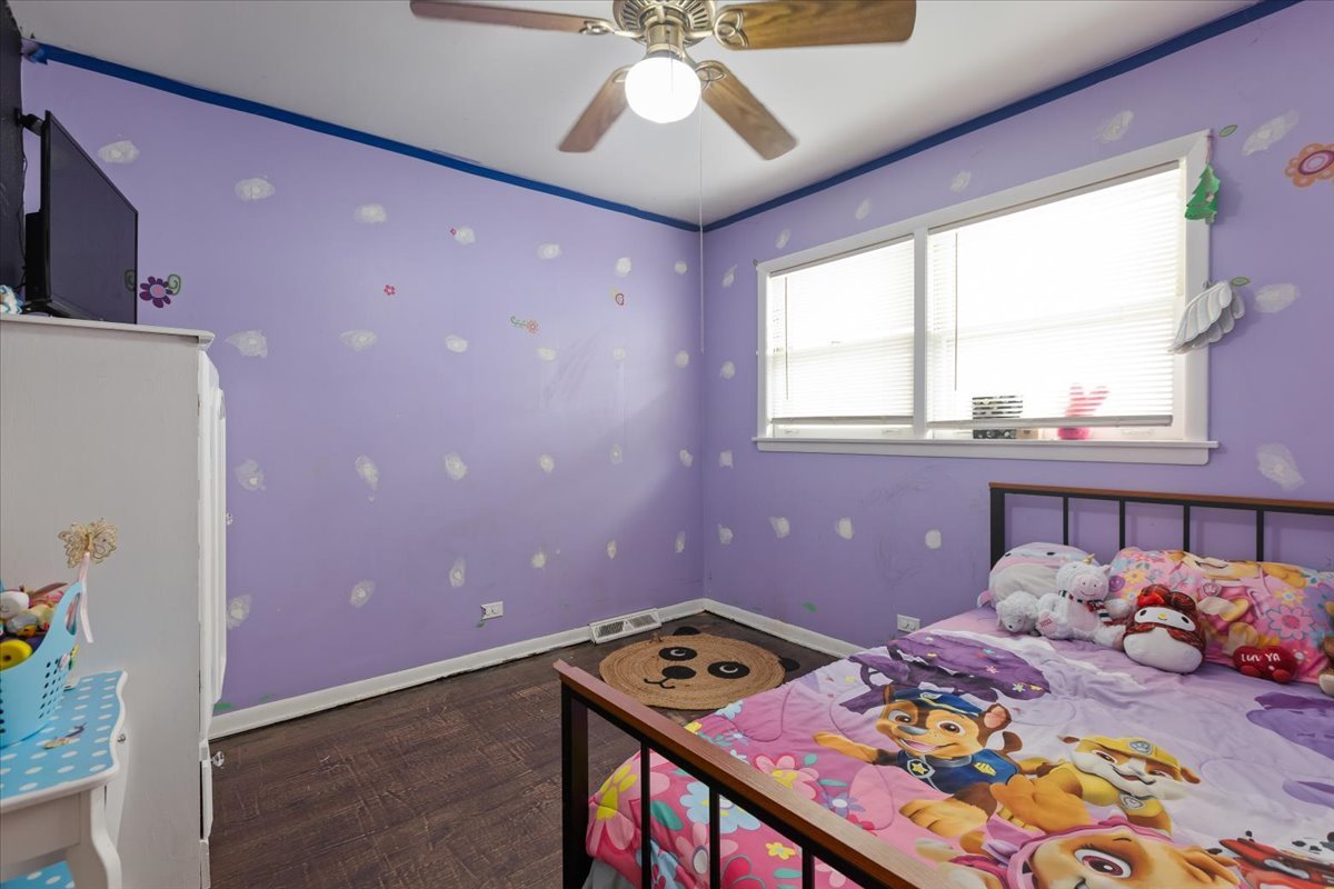 1246 Thomas Street Homewood, IL 60430 - Photo 14 of 29 a bedroom with a bed and a chandelier