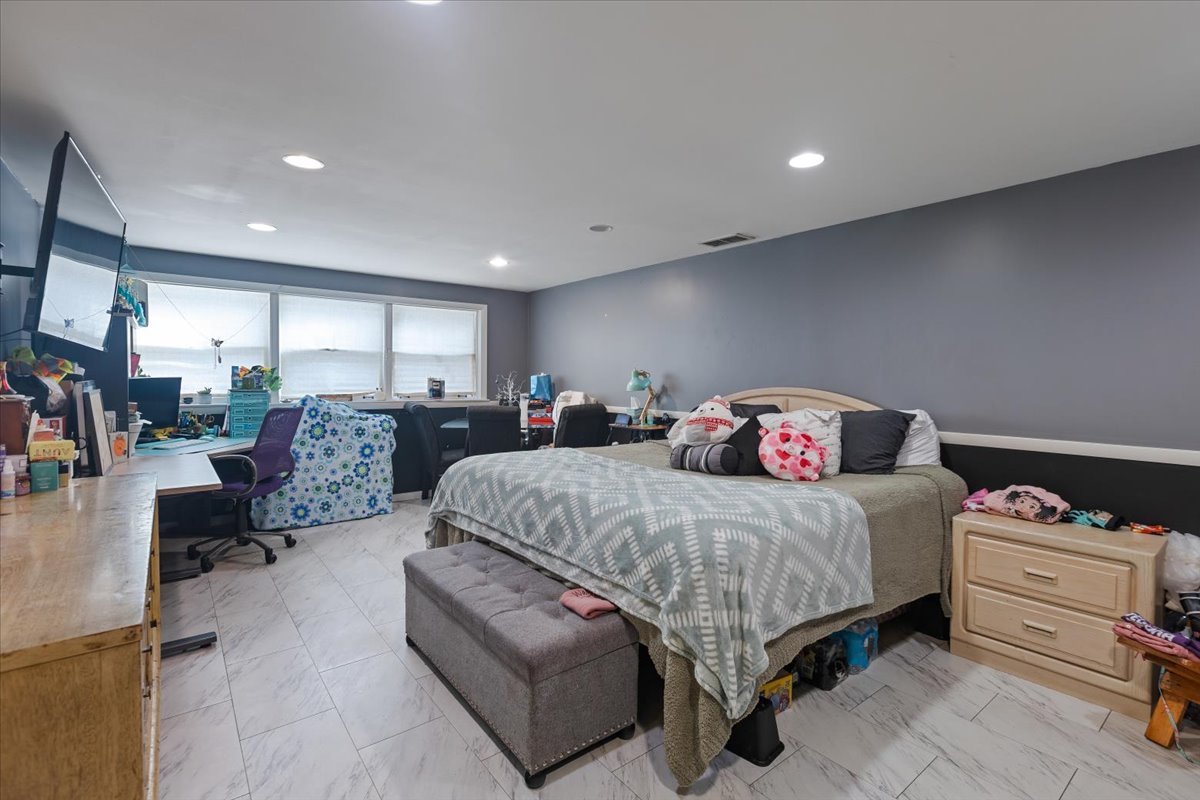 1246 Thomas Street Homewood, IL 60430 - Photo 18 of 29 a spacious bedroom with a bed a couch and a view of kitchen