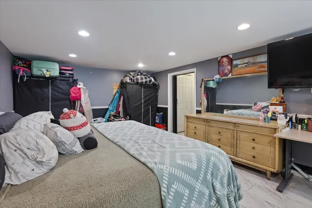 a very nice looking bedroom with a bed and a flat screen tv