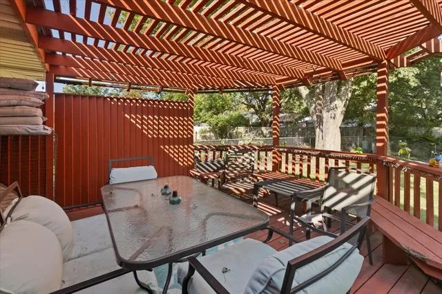 a view of a patio with a table chairs and a backyard