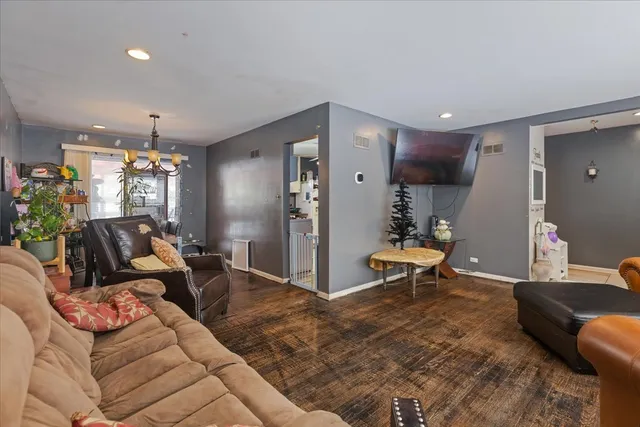 a living room with furniture and a chandelier