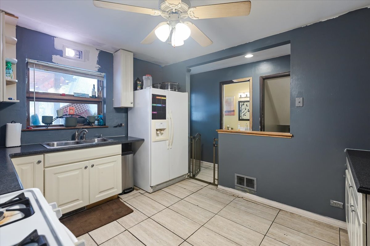 1246 Thomas Street Homewood, IL 60430 - Photo 9 of 29 a kitchen with stainless steel appliances kitchen island granite countertop a refrigerator and a sink