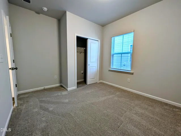 a bathroom with a granite countertop toilet sink and mirror