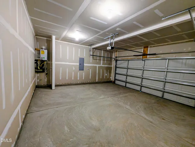 an empty room with windows and fireplace