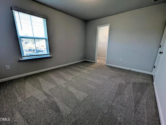 a view of a bedroom from a corridor