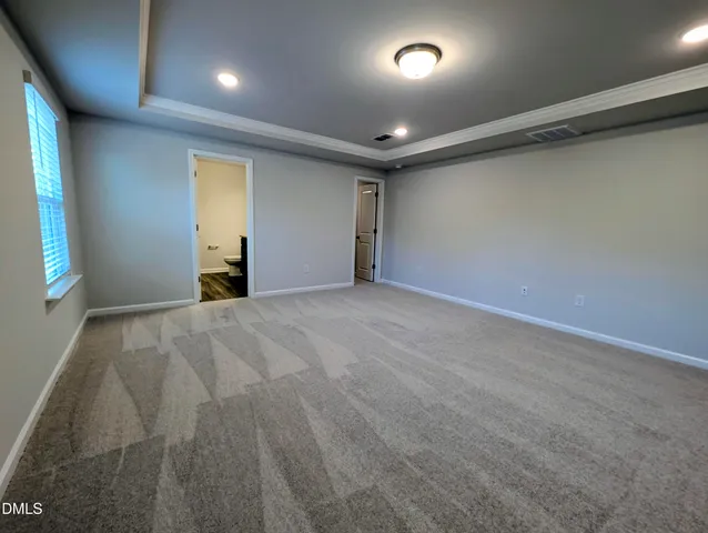 a bathroom with a granite countertop sink a toilet and a mirror