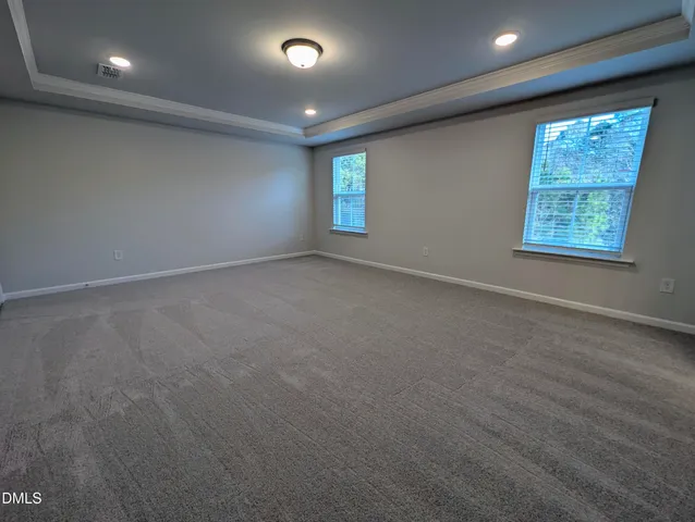 a bathroom with a granite countertop sink a mirror and shower