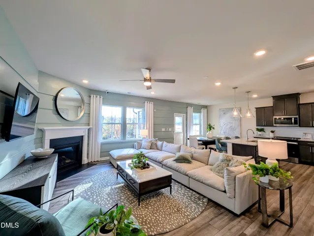 a living room with fireplace furniture and a fireplace