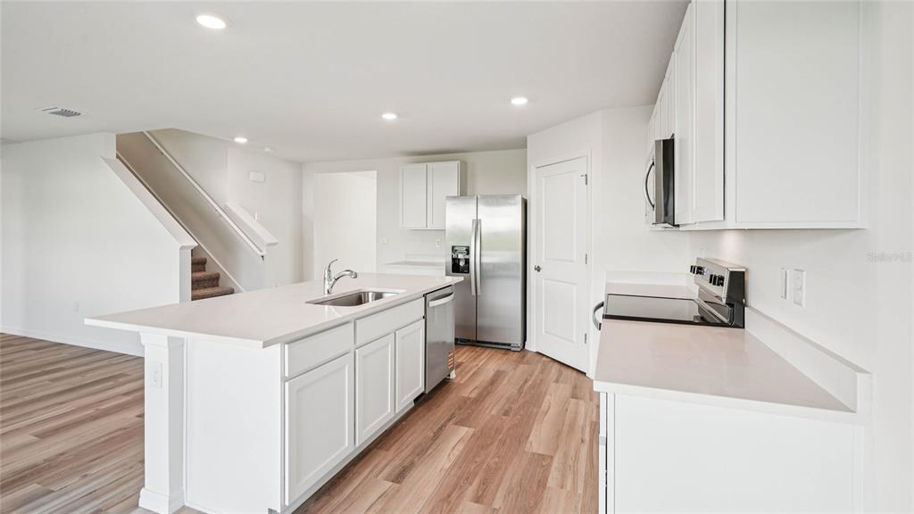 4615 Southwest 88 Place Ocala, FL 34476 - Photo 11 of 16 a kitchen with a sink a stove and a refrigerator