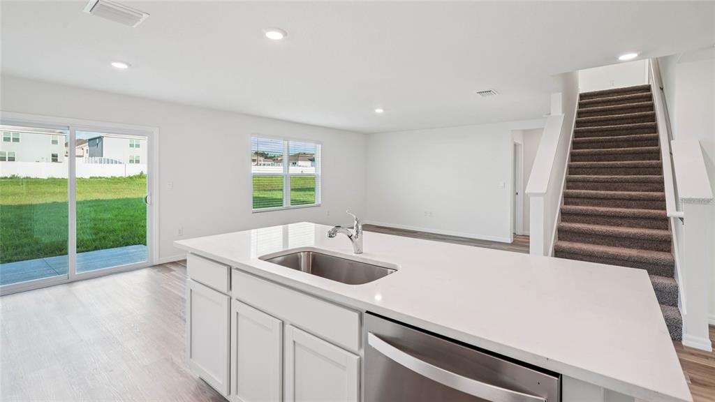 4615 Southwest 88 Place Ocala, FL 34476 - Photo 12 of 16 a kitchen with a sink and wooden floor