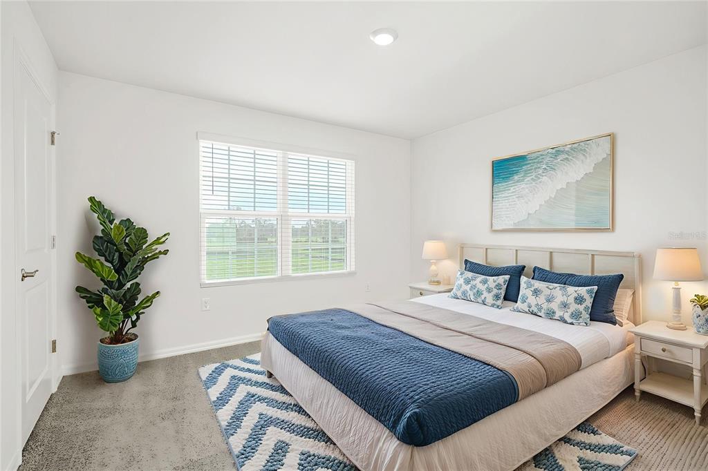 4615 Southwest 88 Place Ocala, FL 34476 - Photo 8 of 16 a bedroom with bed and a potted plant