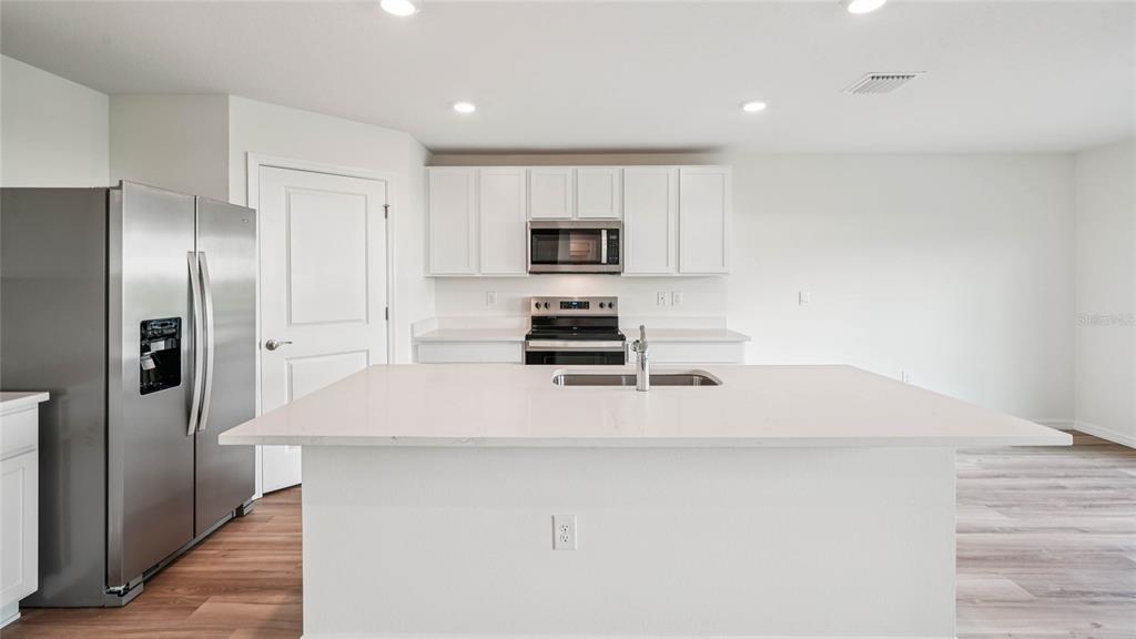 4615 Southwest 88 Place Ocala, FL 34476 - Photo 10 of 16 a kitchen with a refrigerator and a stove top oven