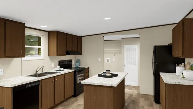a kitchen with granite countertop a sink stove and refrigerator
