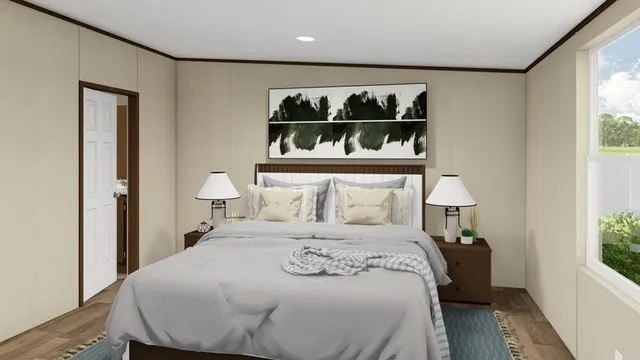 a bedroom with a bed and a large window