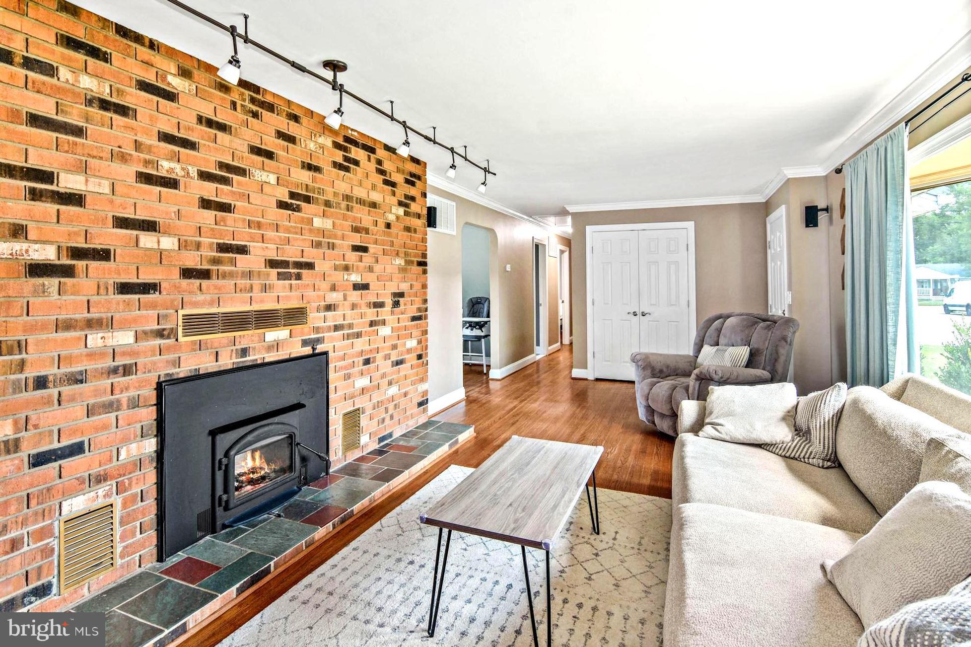 8479 Sexton Road Pasadena, MD 21122 - Photo 11 of 35 Brick Encased Wood Stove with Slate Hearth