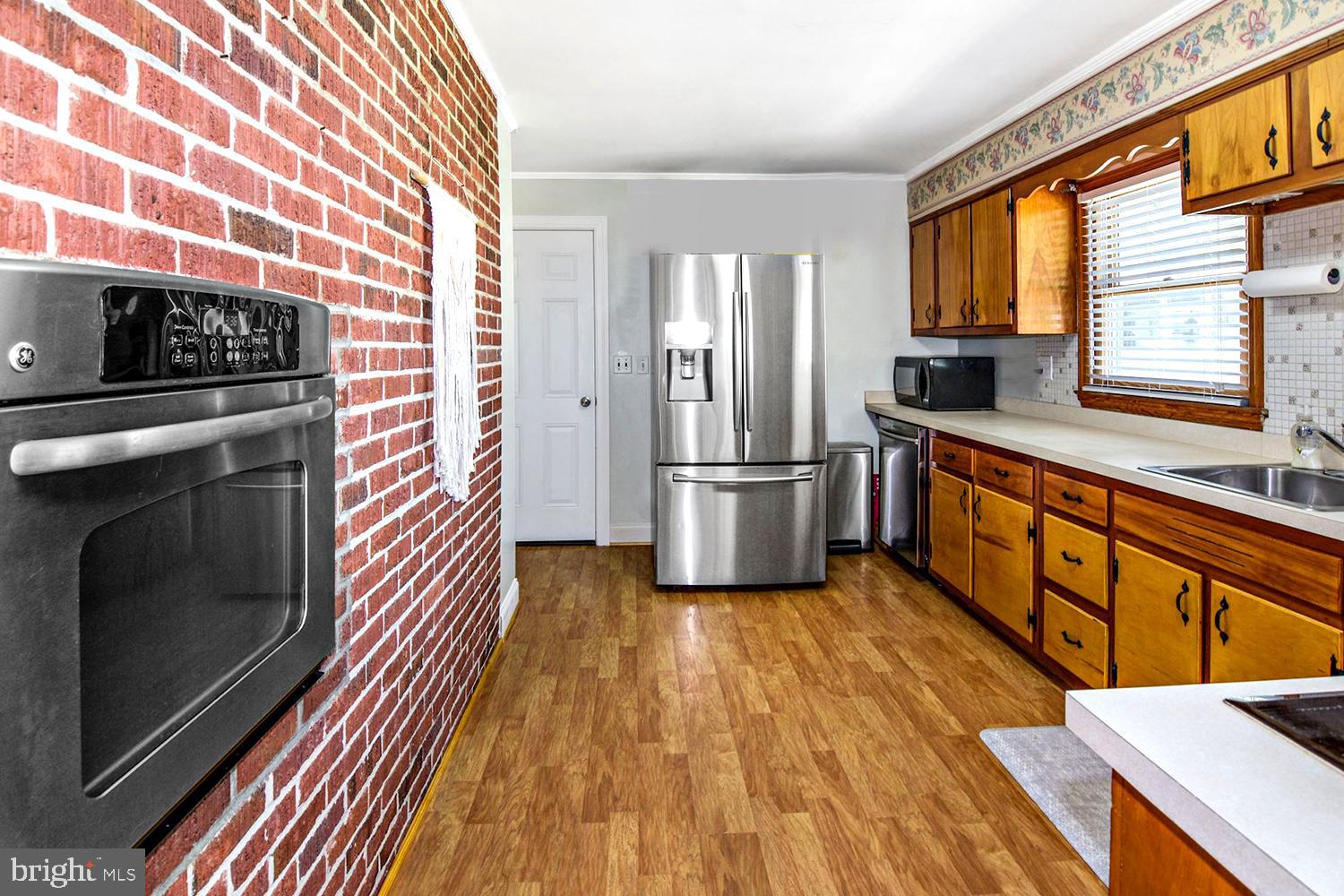 8479 Sexton Road Pasadena, MD 21122 - Photo 15 of 35 Exposed Brick . Sleek Stainless Appliances