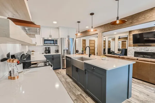 a kitchen with stainless steel appliances sink stove refrigerator and cabinets
