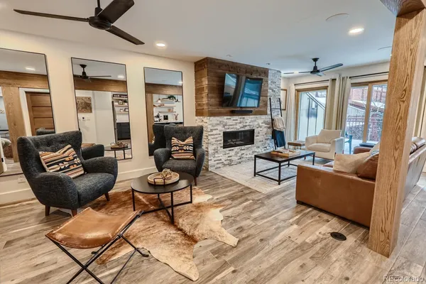 a living room with furniture a fireplace and a flat screen tv