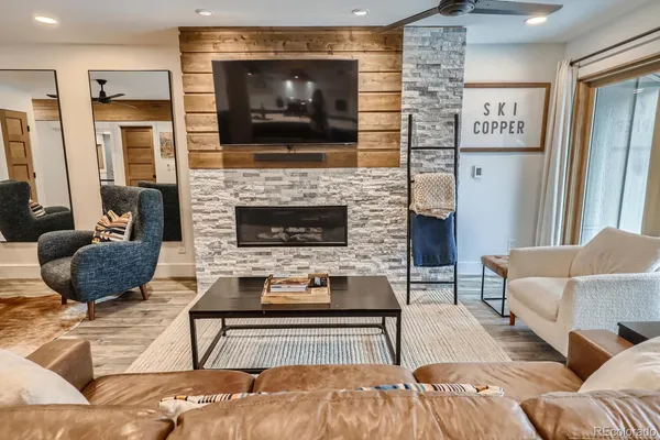 a living room with furniture and a fireplace