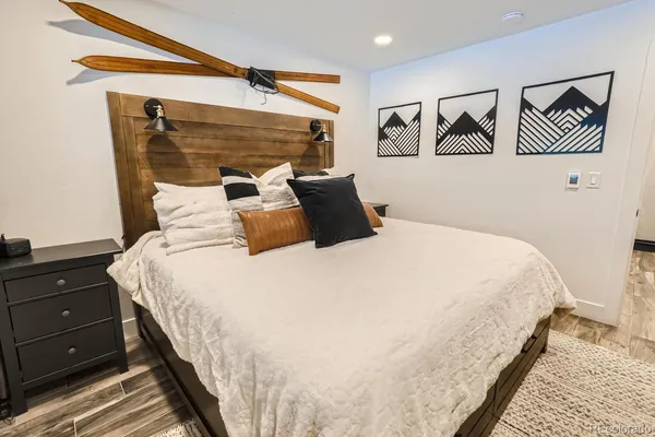 a large bed sitting in a bedroom next to a window