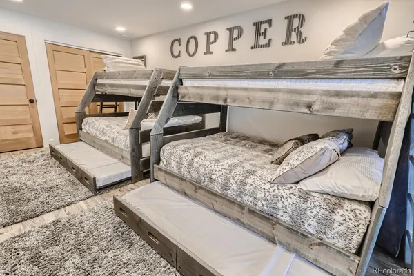 a bedroom with a bed and washing machine