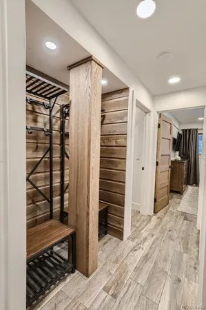 a view of hallway with wooden floor and closet