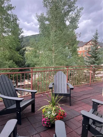 a view of a wooden deck with furniture