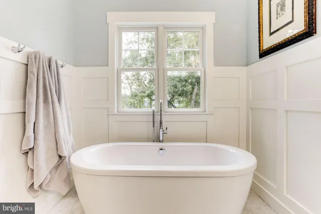 a white bath tub sitting next to a white sink
