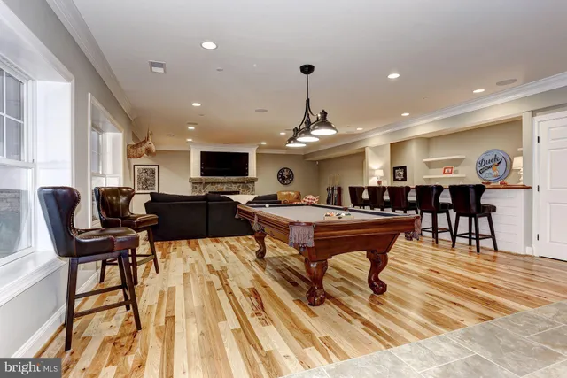 a living room with furniture a wooden floor and next to a window
