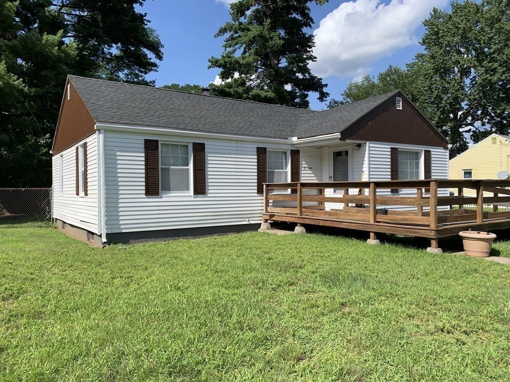 54 Fernald Street Springfield, MA 01109 - Photo 2 of 13 a backyard of a house with barbeque oven and trees