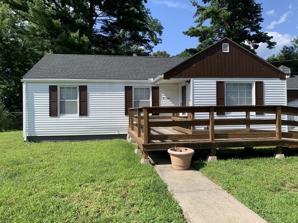 54 Fernald Street Springfield, MA 01109 - Photo 3 of 13 a backyard of a house with wooden fence and a bench