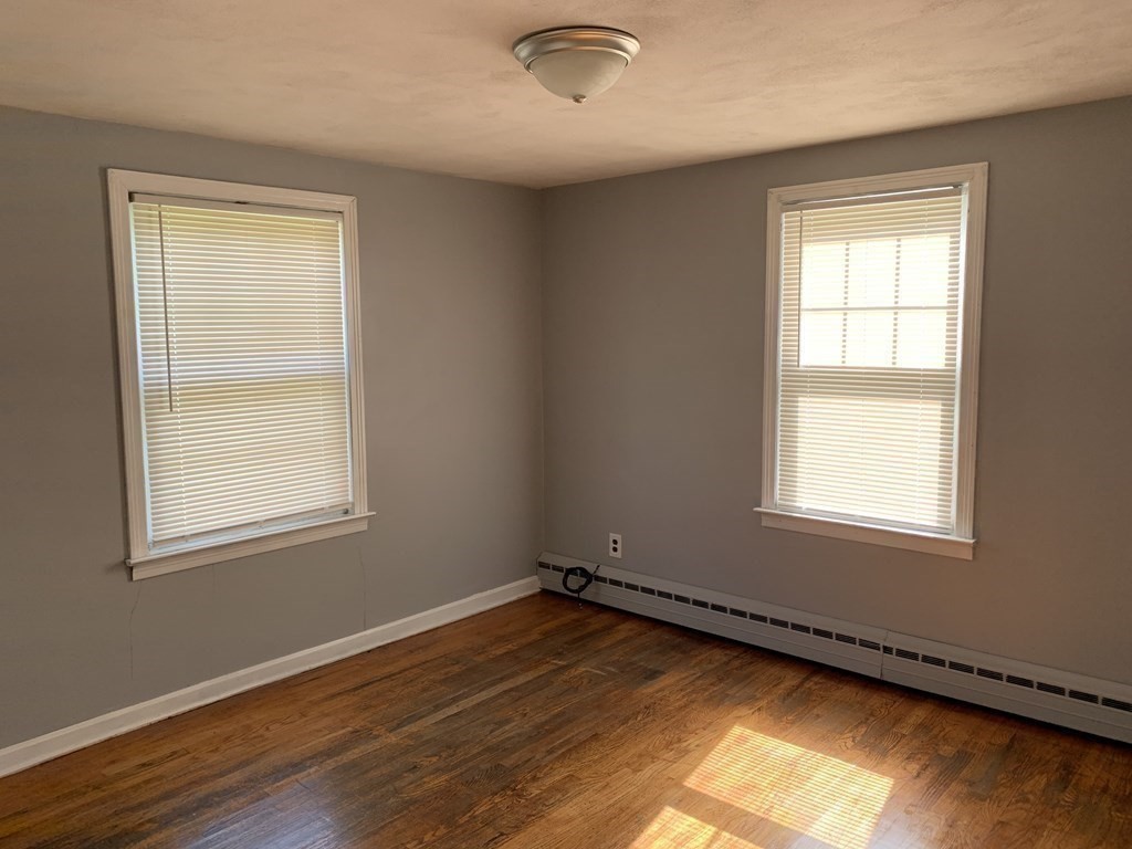 54 Fernald Street Springfield, MA 01109 - Photo 7 of 13 a view of an empty room with wooden floor and a window