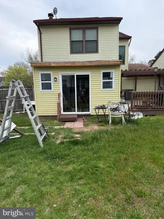 a view of backyard of a house with seating space
