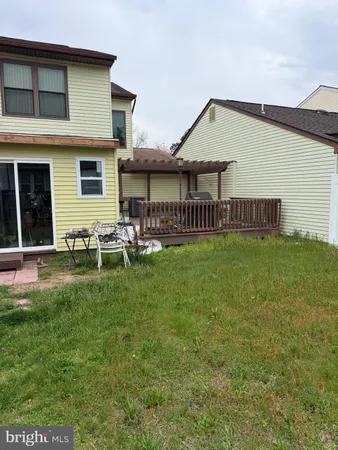 a view of a house with a yard and sitting area