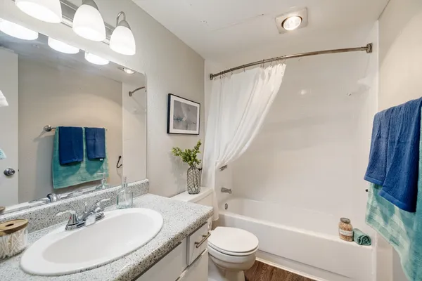 a bathroom with a sink toilet and shower