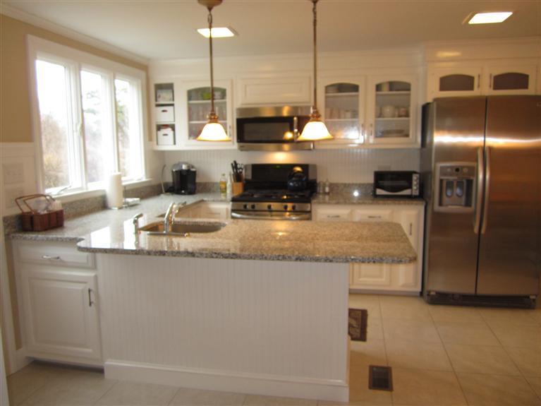 65 Bone Hill Road Barnstable, MA 02675 - Photo 14 of 34 a kitchen with stainless steel appliances granite countertop a sink a stove and a refrigerator