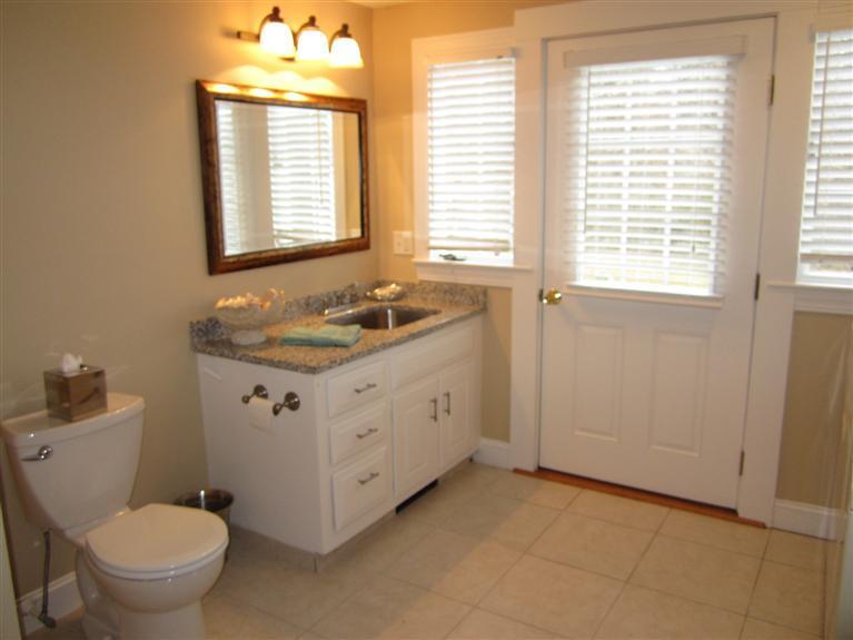 65 Bone Hill Road Barnstable, MA 02675 - Photo 20 of 34 a spacious bathroom with a granite countertop toilet a sink and a window