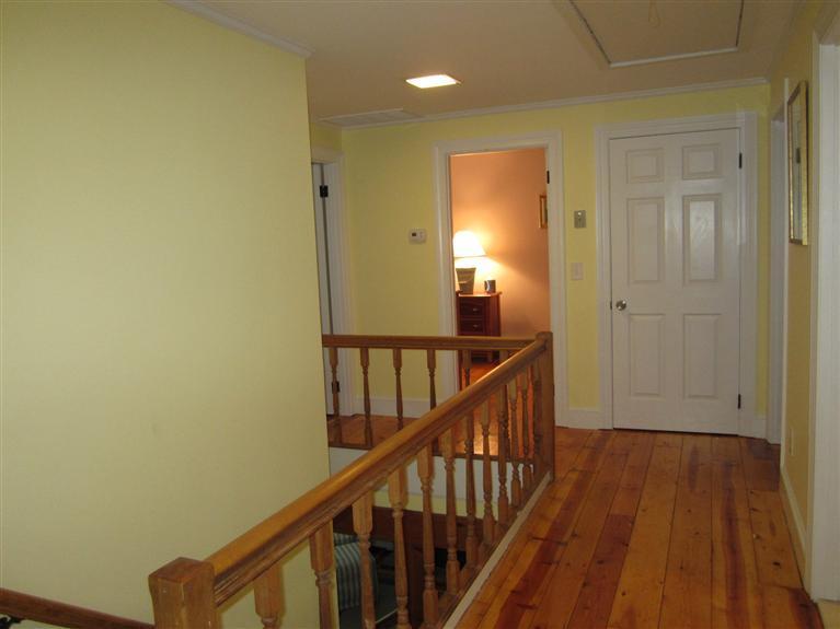 65 Bone Hill Road Barnstable, MA 02675 - Photo 21 of 34 a view of a hallway with wooden floor and staircase