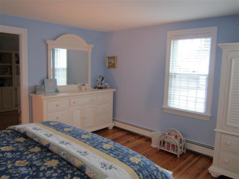 65 Bone Hill Road Barnstable, MA 02675 - Photo 26 of 34 a bedroom with a bed and wooden floor