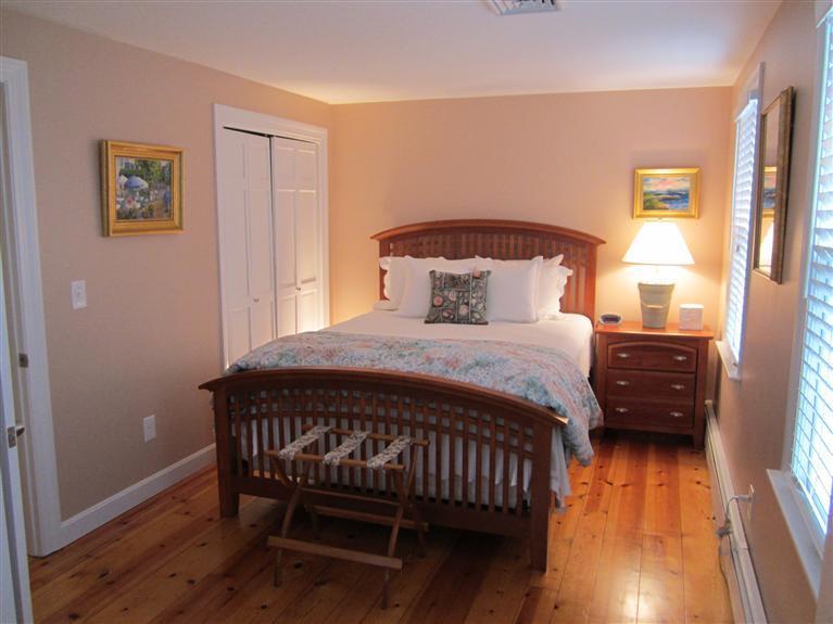 65 Bone Hill Road Barnstable, MA 02675 - Photo 27 of 34 a bedroom with a bed and wooden floor