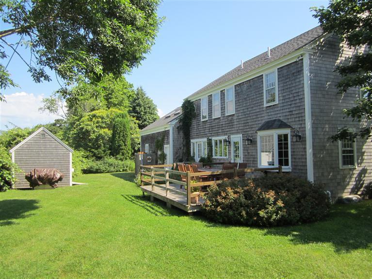 65 Bone Hill Road Barnstable, MA 02675 - Photo 3 of 34 a front view of a house with a garden and yard