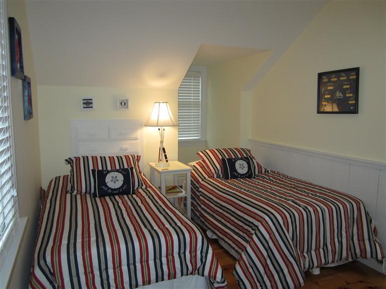 65 Bone Hill Road Barnstable, MA 02675 - Photo 32 of 34 a bedroom with two beds and a dresser next to a window
