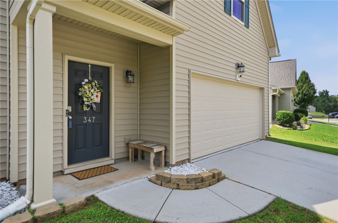 347 Riverdale Road Simpsonville, SC 29680 - Photo 2 of 30 A welcoming entry, complete with an attached garage and a neatly maintained front yard.