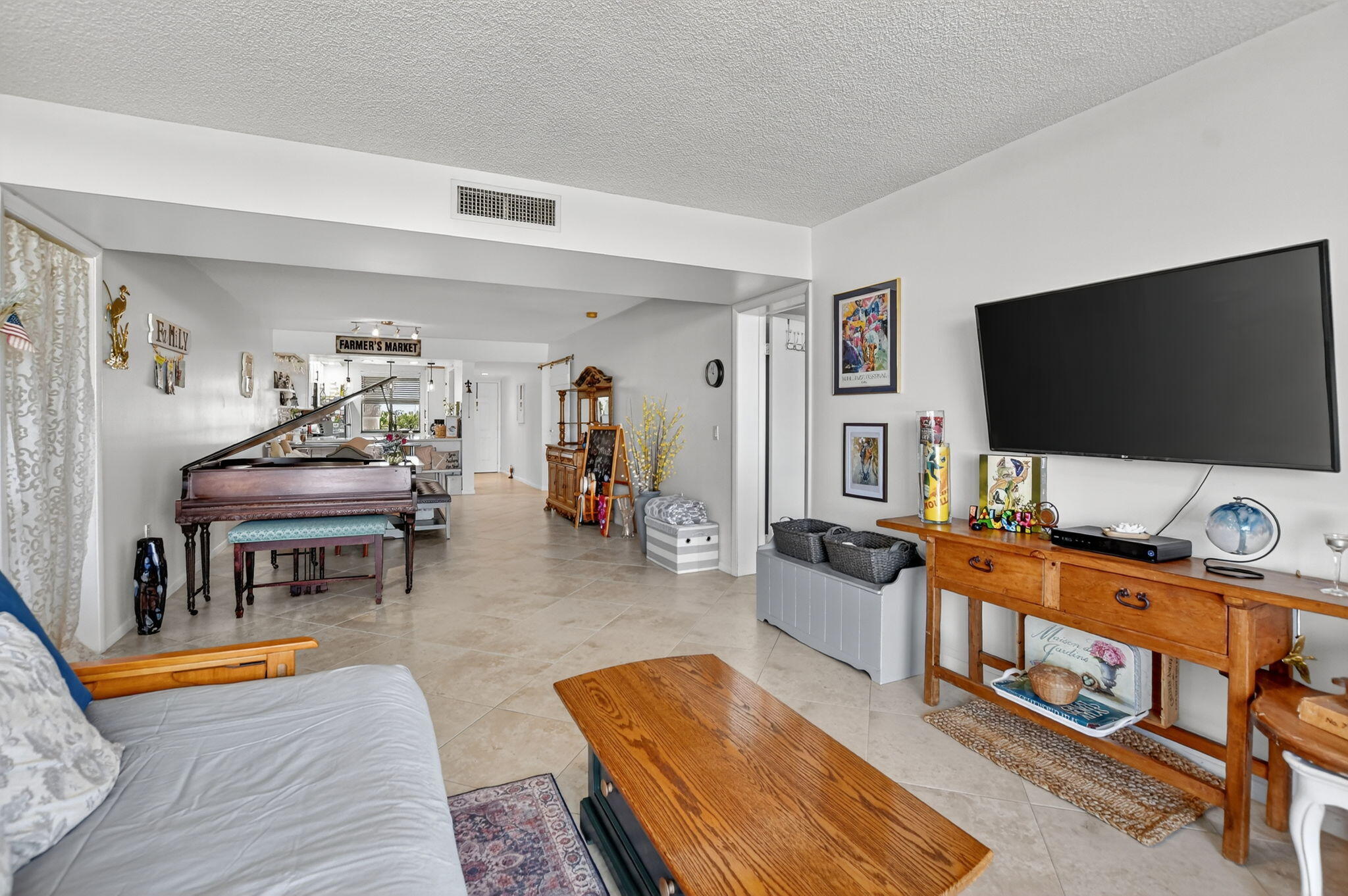 6205 Balboa Circle, Unit 403 Boca Raton, FL 33433 - Photo 11 of 41 a living room with furniture and a flat screen tv