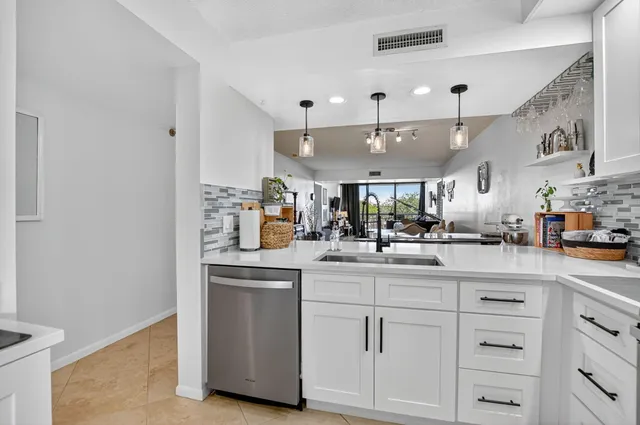 a kitchen with cabinets and window